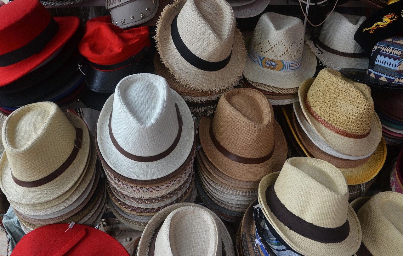 Display of finished custom embroidered hats showing range of colors and design quality